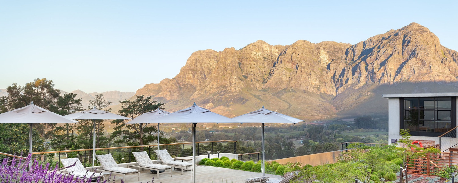 De Zeven Guest Lodge, mountain views and pool deck. Located in Banhoek Valley, near Stellenbosch and Franschhoek, Cape Winelands South Africa.
